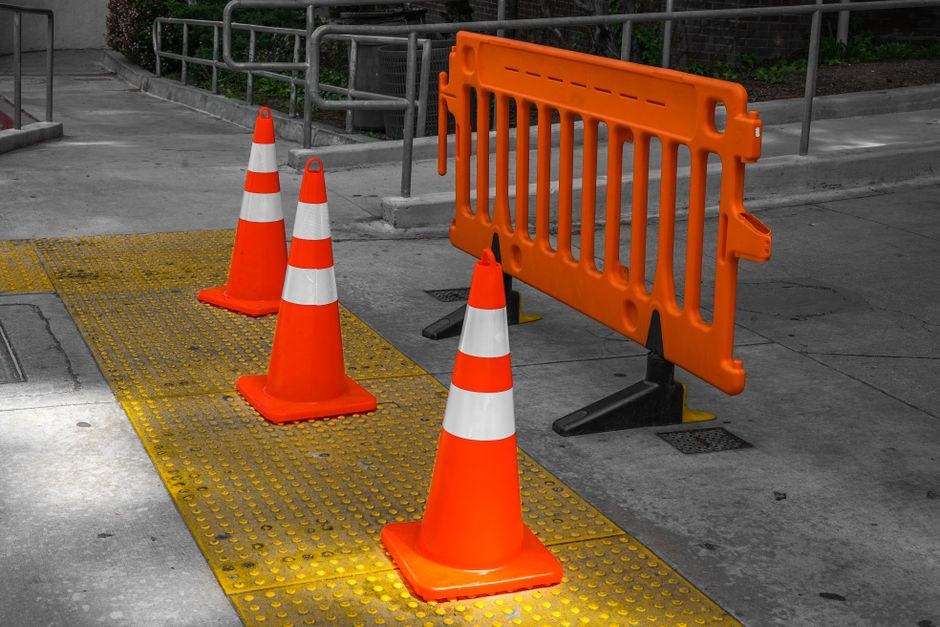 Arkistokuva: Oransseja liikennekartioita ja sulkuaita jalkakäytävällä.